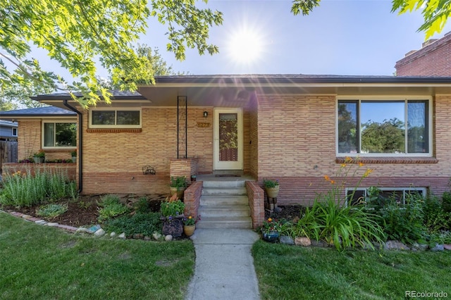 6273 S Prescott St, Littleton, CO 80120 - view of front of home with a front yard and brick siding