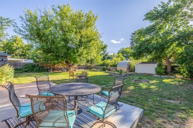 6273 S Prescott St, Littleton, CO 80120 - wooden deck with outdoor dining space, a storage shed, a fenced backyard, and a patio area