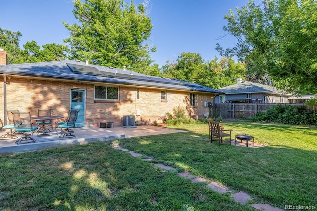 6273 S Prescott St, Littleton, CO 80120 - back of property featuring a fire pit, solar panels, a patio, and brick siding