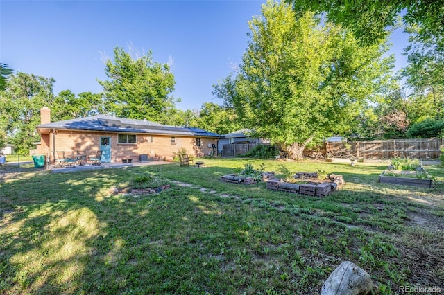 6273 S Prescott St, Littleton, CO 80120 - fenced backyard featuring a vegetable garden and a patio