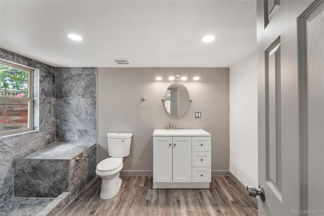 bathroom featuring vanity, wood-type flooring, and toilet