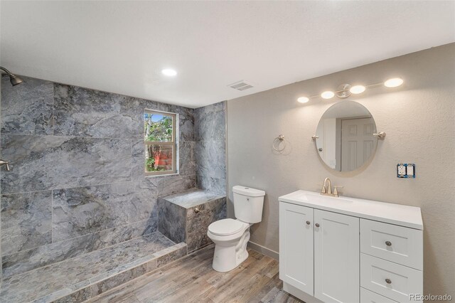 bathroom with vanity, wood-type flooring, toilet, and walk in shower