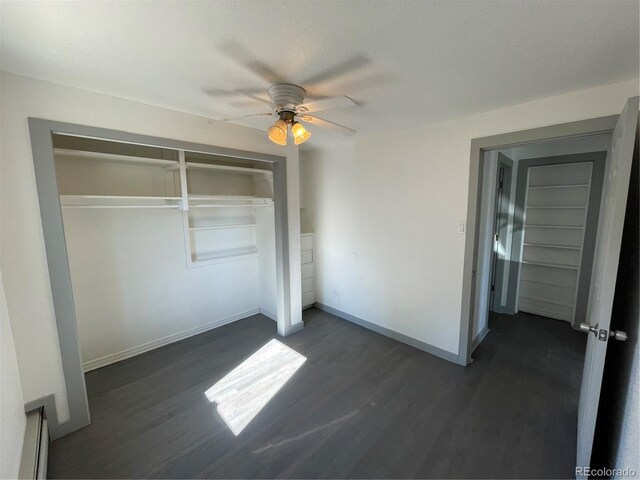 unfurnished bedroom with dark hardwood / wood-style flooring, a textured ceiling, a closet, and ceiling fan