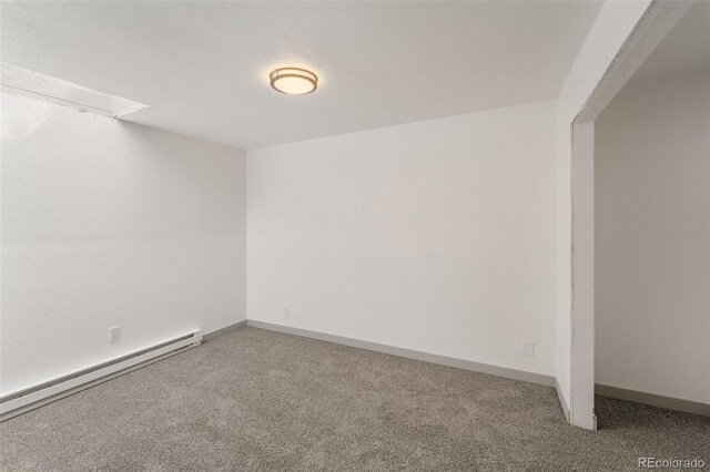 spare room with carpet flooring and baseboard heating