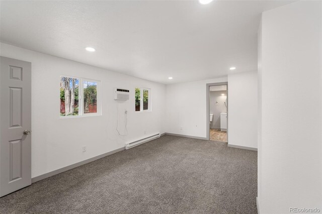 carpeted spare room with baseboard heating and a wall mounted AC