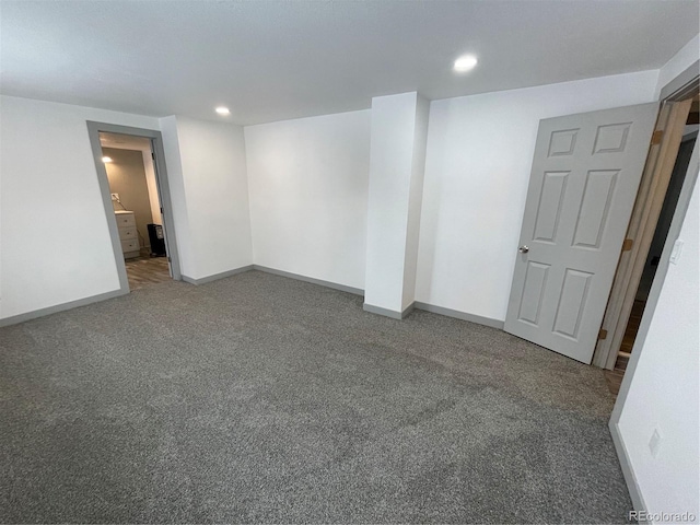 empty room featuring dark colored carpet