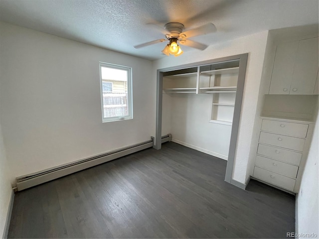 unfurnished bedroom with dark wood-type flooring, a textured ceiling, a closet, ceiling fan, and a baseboard heating unit