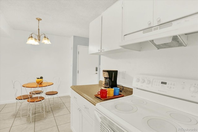10211 Ura Ln Unit 101, Thornton, CO 80260 - kitchen featuring white range with electric cooktop, under cabinet range hood, light tile patterned floors, a chandelier, and white cabinets