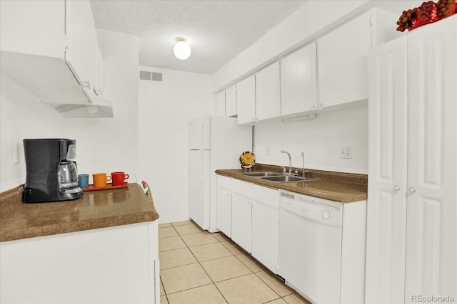 10211 Ura Ln Unit 101, Thornton, CO 80260 - kitchen featuring white appliances, dark countertops, white cabinets, light tile patterned flooring, and a textured ceiling