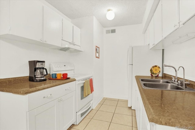 10211 Ura Ln Unit 101, Thornton, CO 80260 - kitchen featuring electric range, under cabinet range hood, a textured ceiling, white cabinetry, and light tile patterned flooring