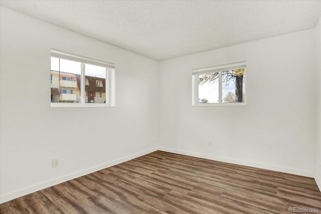 10211 Ura Ln Unit 101, Thornton, CO 80260 - unfurnished room with wood finished floors and a textured ceiling