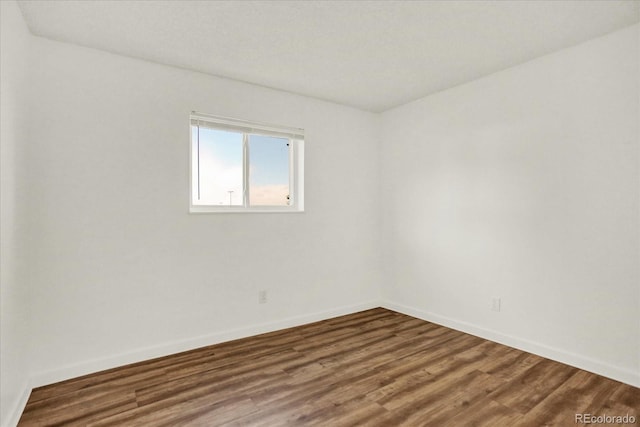 10211 Ura Ln Unit 101, Thornton, CO 80260 - empty room with baseboards and wood finished floors