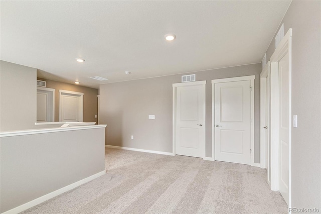 unfurnished room with light colored carpet