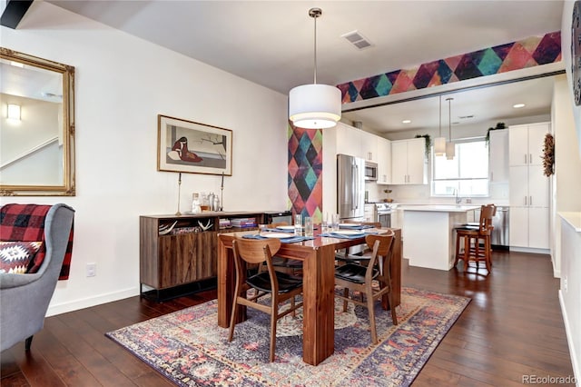 852 Kalamath St, Denver, CO 80204 - dining room featuring dark wood-style floors and baseboards