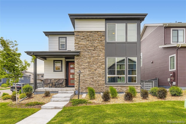 6211 Stable View St, Castle Pines, CO 80108 - contemporary home featuring stone siding, a porch, and a front yard