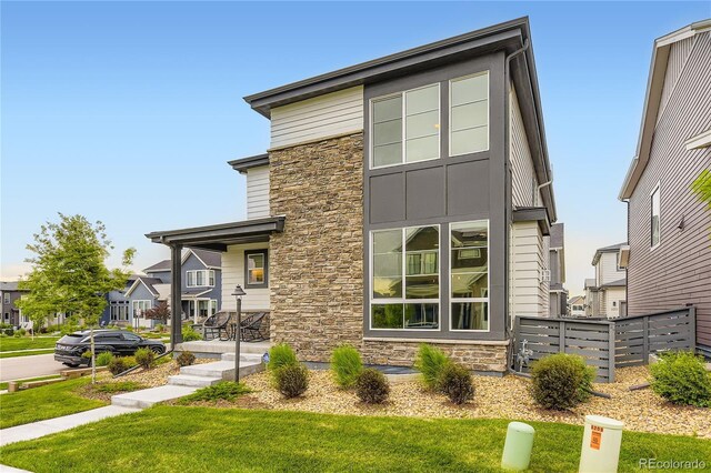 6211 Stable View St, Castle Pines, CO 80108 - contemporary home with stone siding, board and batten siding, and a porch