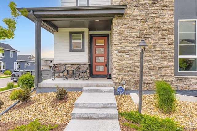 6211 Stable View St, Castle Pines, CO 80108 - doorway to property with a porch and stone siding