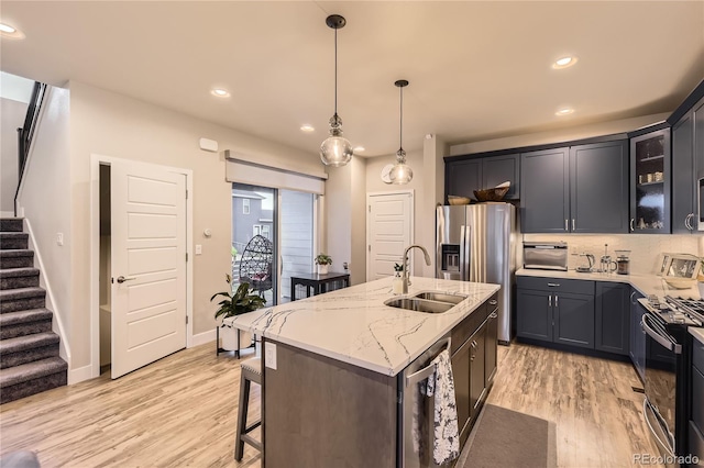 6211 Stable View St, Castle Pines, CO 80108 - kitchen with stainless steel appliances, recessed lighting, light wood-style floors, glass insert cabinets, and light stone countertops