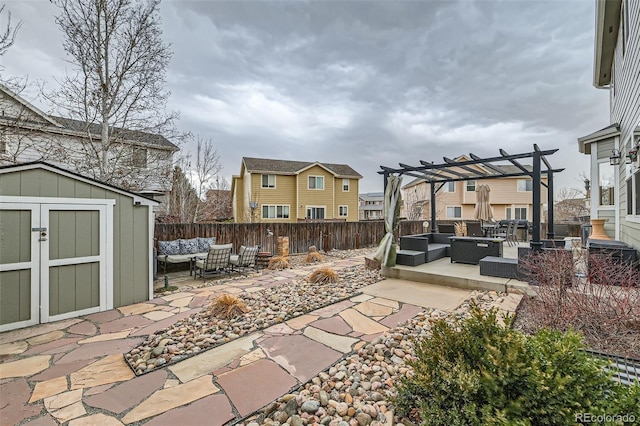 view of patio featuring an outdoor living space with a fire pit, fence, a storage unit, an outdoor structure, and a pergola