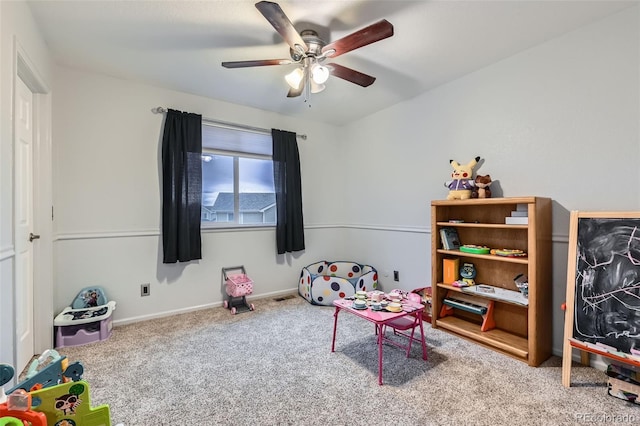 rec room with carpet, ceiling fan, and baseboards