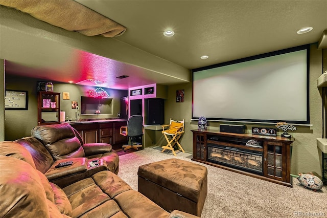 home theater room featuring carpet floors, a textured wall, a textured ceiling, and recessed lighting