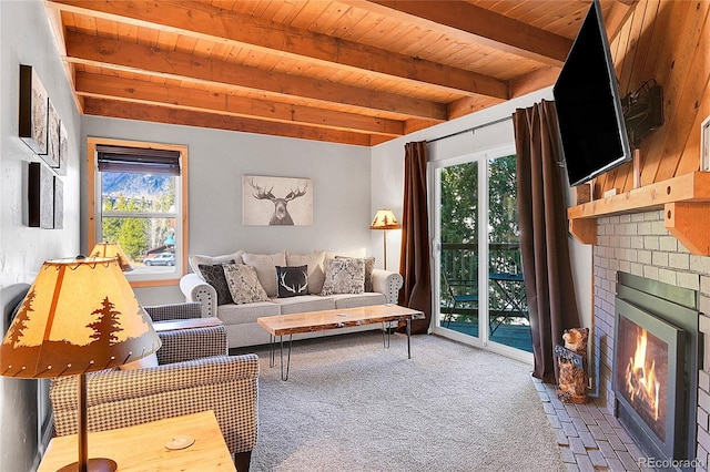 carpeted living room with a healthy amount of sunlight, wooden ceiling, beamed ceiling, and a fireplace