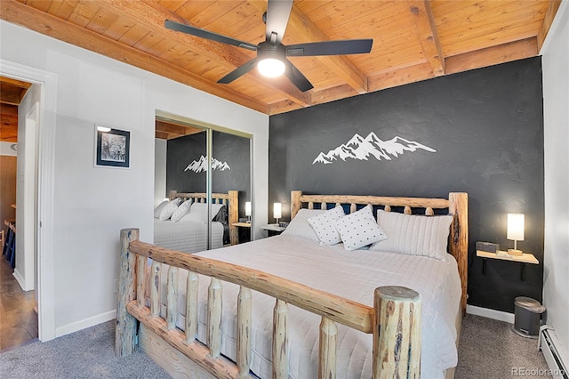 carpeted bedroom with wood ceiling, a closet, beam ceiling, a baseboard heating unit, and ceiling fan