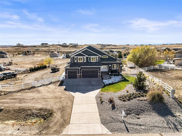 view of front of property with a rural view and a garage