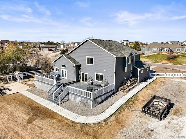 back of property featuring a wooden deck