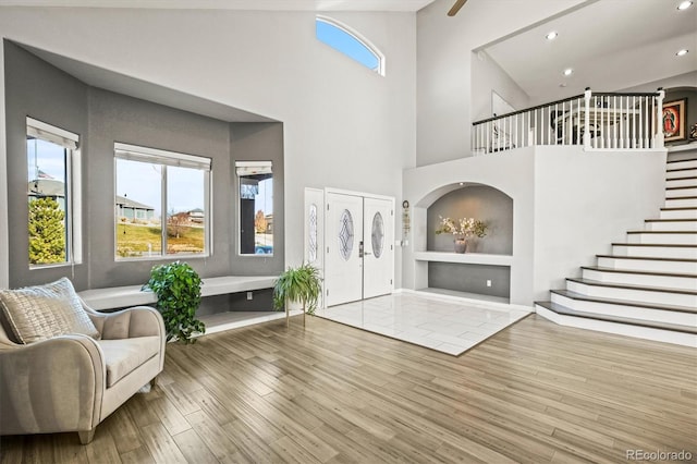 entrance foyer with hardwood / wood-style floors and a high ceiling