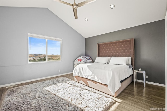 bedroom featuring dark hardwood / wood-style flooring, ceiling fan, and lofted ceiling