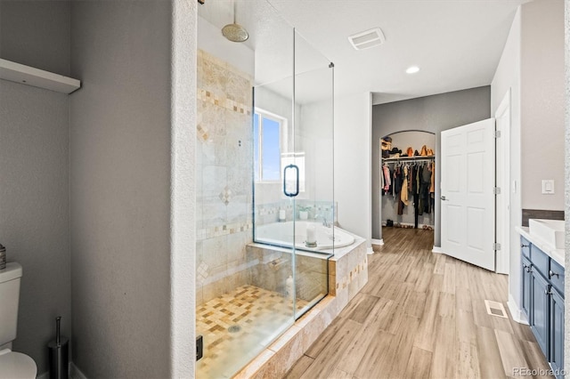 bathroom featuring hardwood / wood-style floors, vanity, and independent shower and bath