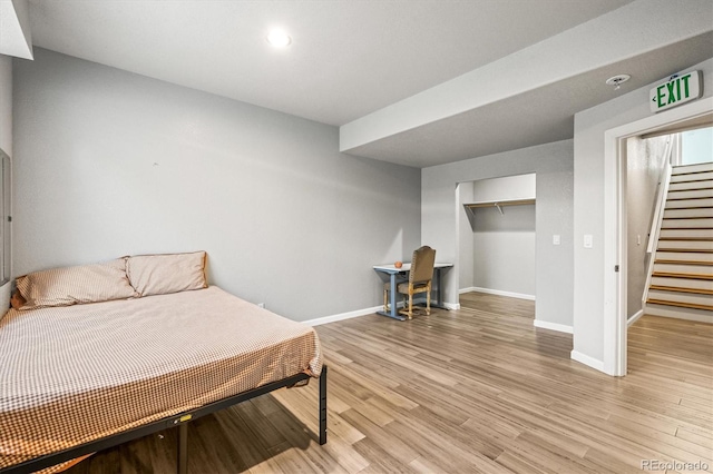 bedroom with light hardwood / wood-style flooring and a closet