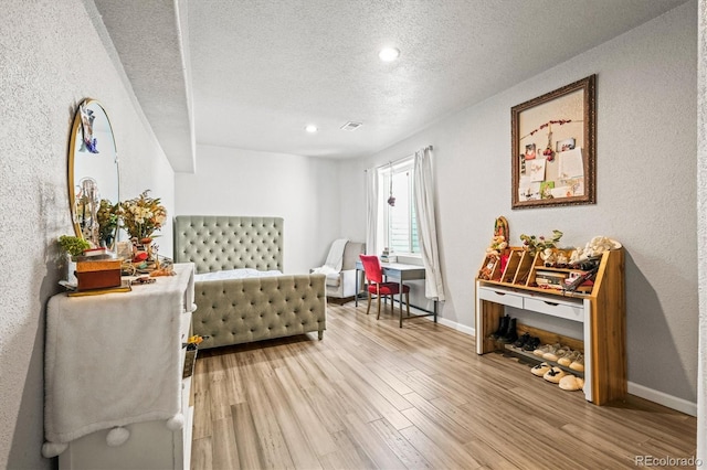 living area featuring wood-type flooring and a textured ceiling