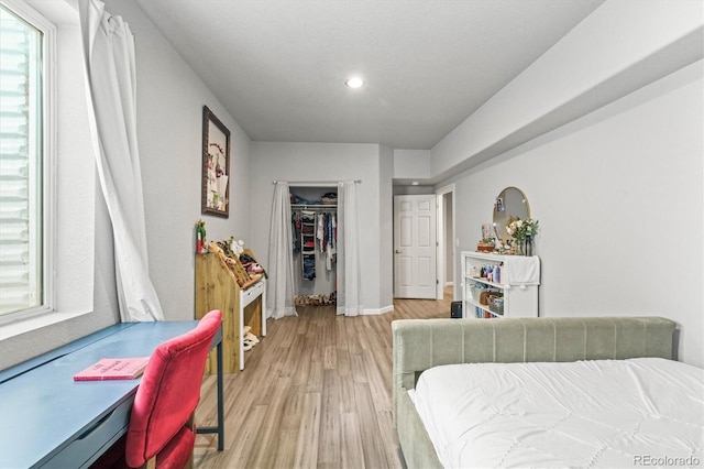 bedroom featuring a closet and light hardwood / wood-style flooring