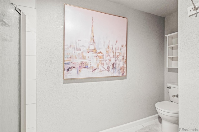 bathroom featuring tile patterned flooring and toilet