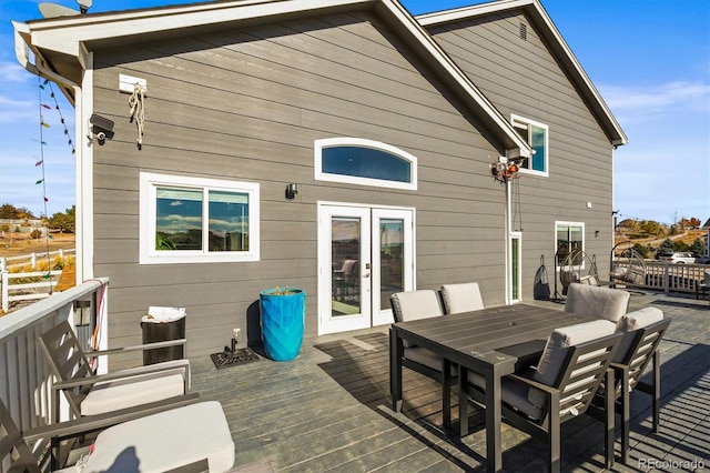 rear view of property featuring a deck and french doors