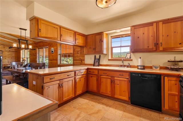 kitchen featuring hanging light fixtures, kitchen peninsula, black appliances, wooden walls, and a chandelier