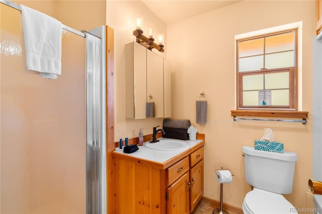 bathroom featuring walk in shower, vanity, and toilet