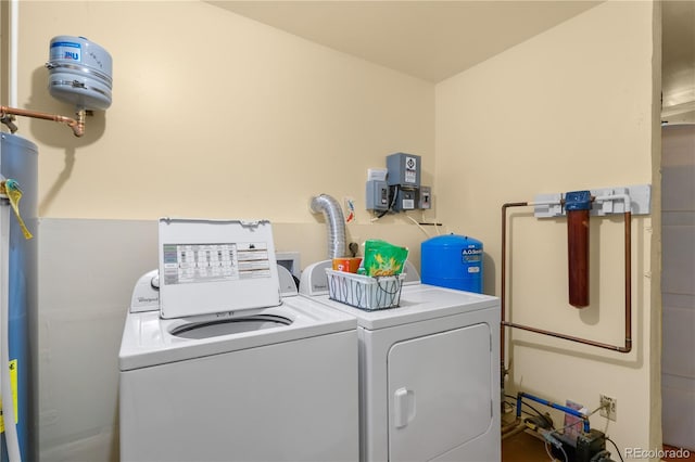 laundry room featuring water heater and washer and dryer