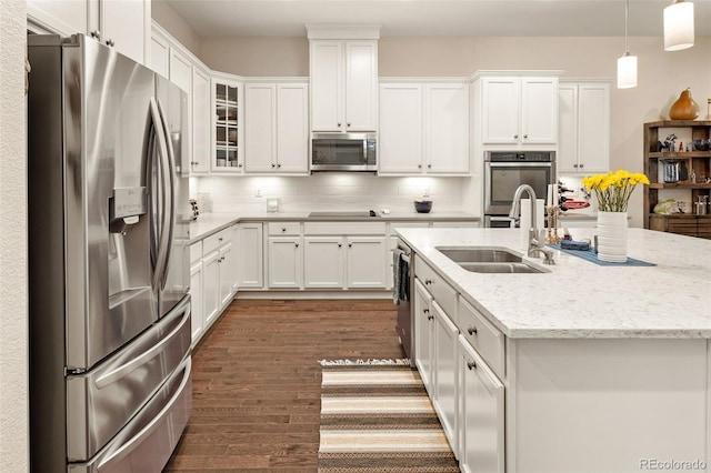 3418 New Haven Cir, Castle Rock, CO 80109 - kitchen featuring stainless steel appliances, a sink, dark wood-style floors, white cabinetry, and a center island with sink