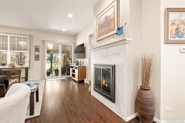 3418 New Haven Cir, Castle Rock, CO 80109 - living room featuring a tile fireplace, dark wood-style flooring, recessed lighting, and baseboards