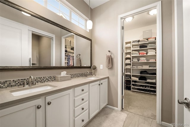 3418 New Haven Cir, Castle Rock, CO 80109 - bathroom with double vanity, a walk in closet, and baseboards