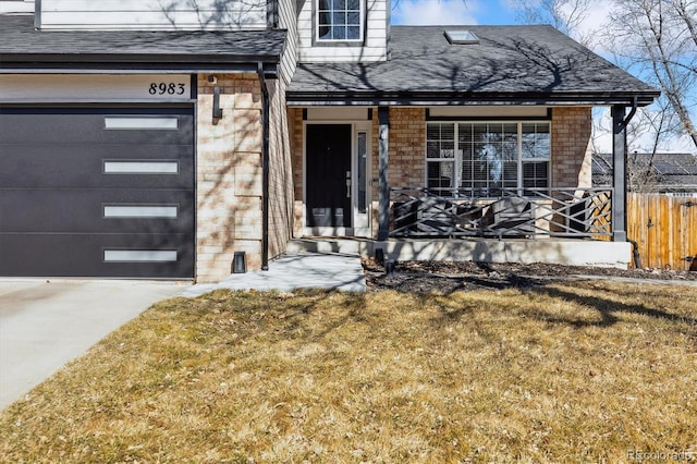 view of exterior entry with concrete driveway, brick siding, a porch, and a shingled roof