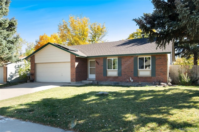 ranch-style house featuring a front yard and a garage