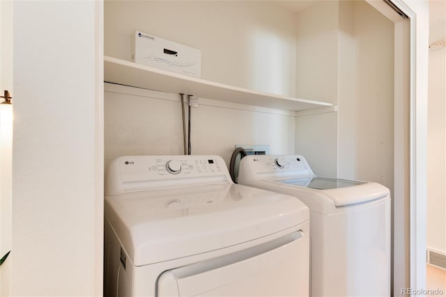 laundry room with washing machine and dryer