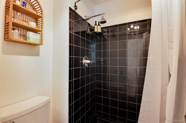 bathroom featuring curtained shower and toilet