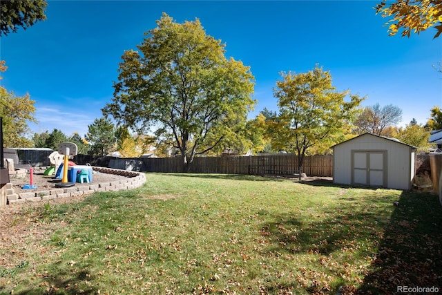 view of yard featuring a storage shed and a playground