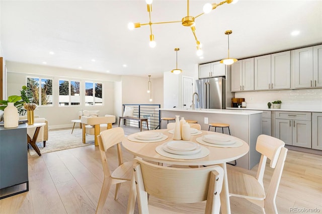 dining area featuring a chandelier and light wood-type flooring