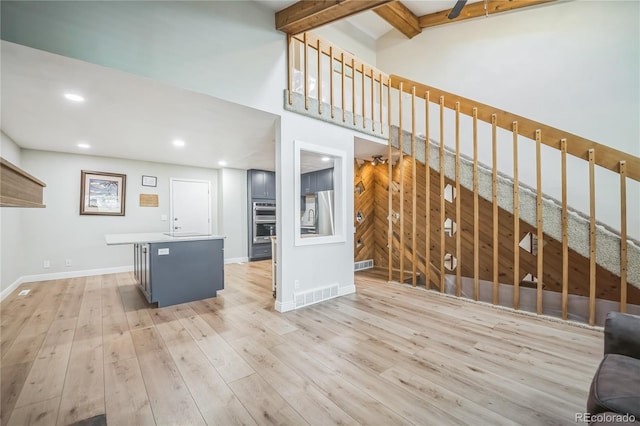 unfurnished living room with baseboards, recessed lighting, wood finished floors, and visible vents